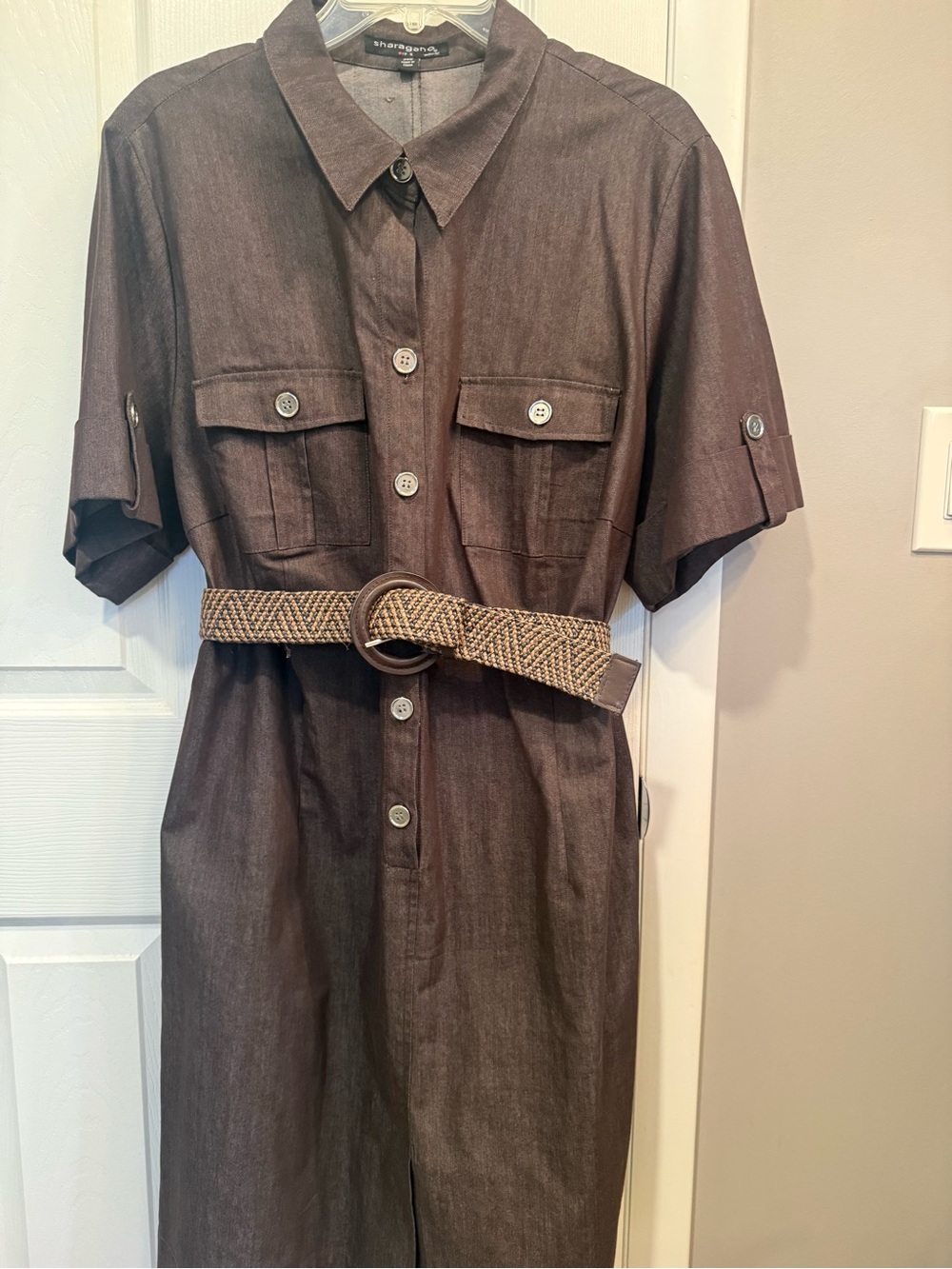 Women’s button front belted dress with split in front. Pockets pointed collar